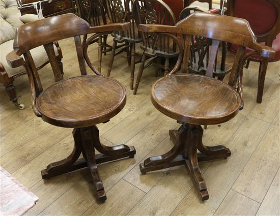 A pair of oak barbers chairs